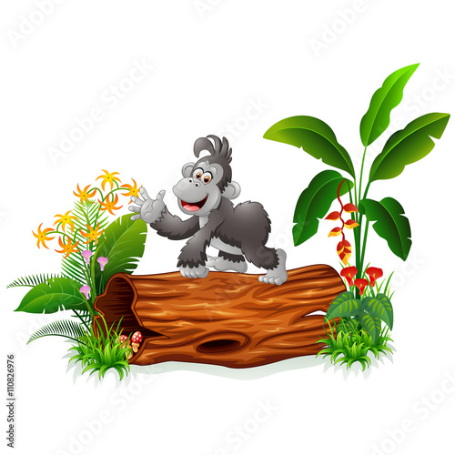 Cute baby gorilla posing on tree stump

