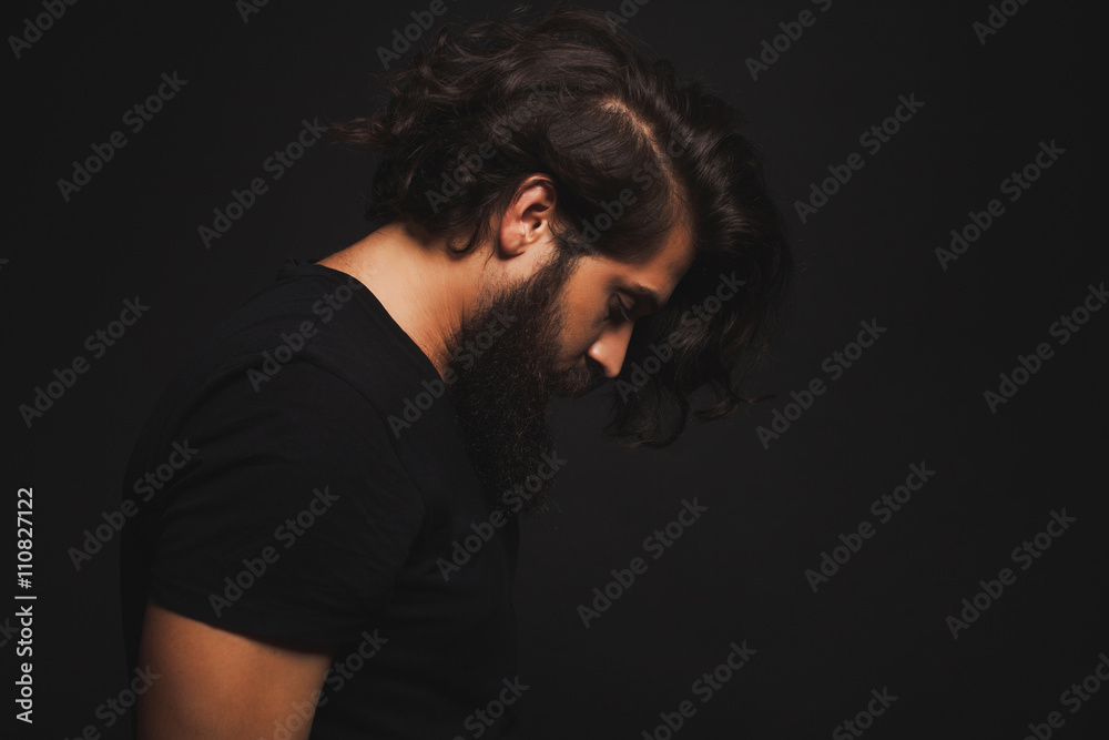 Brutal bearded man outdoor studio portrait.Cool businessman portrait outdoor,muscular body,rock n roll singer,trendy hairstyle man.handsome guy relaxing at grass