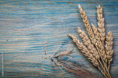 Wheat rye ears on wooden board food and drink concept