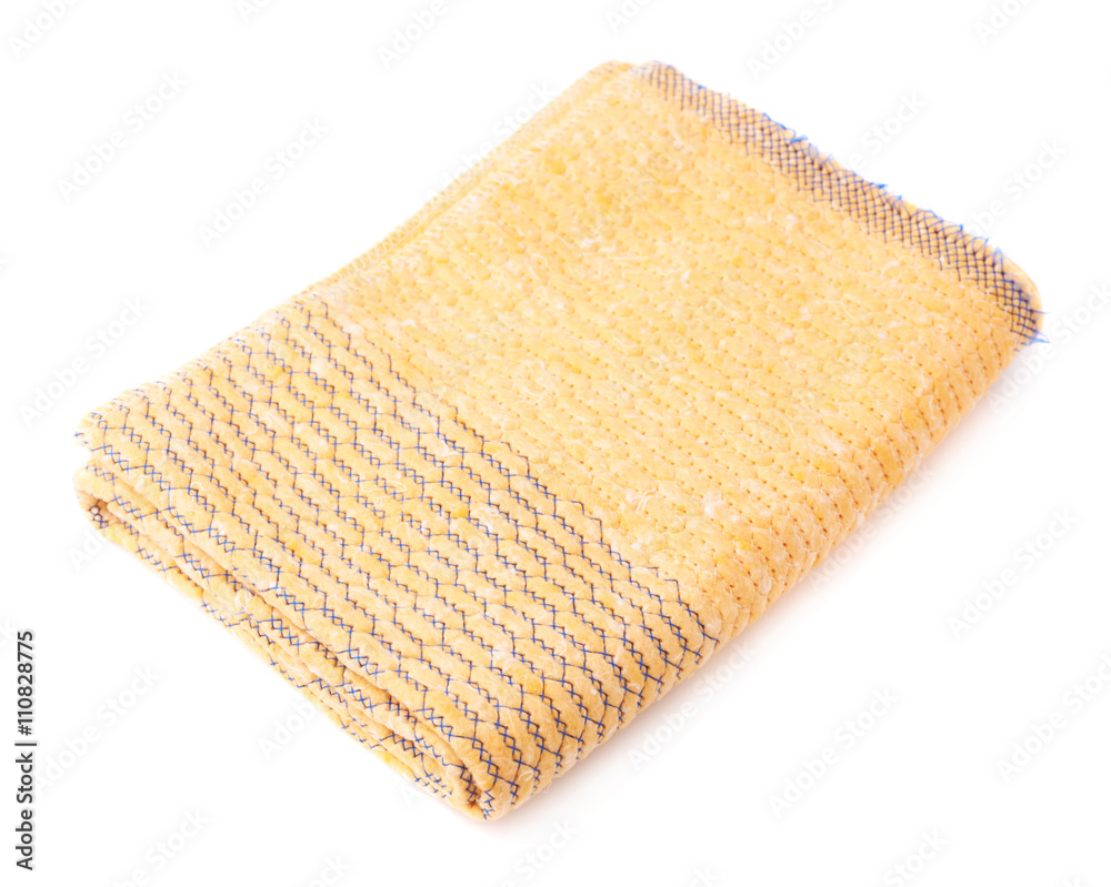 Folded yellow towel isolated over the white background Folded yellow towel isolated over the white background