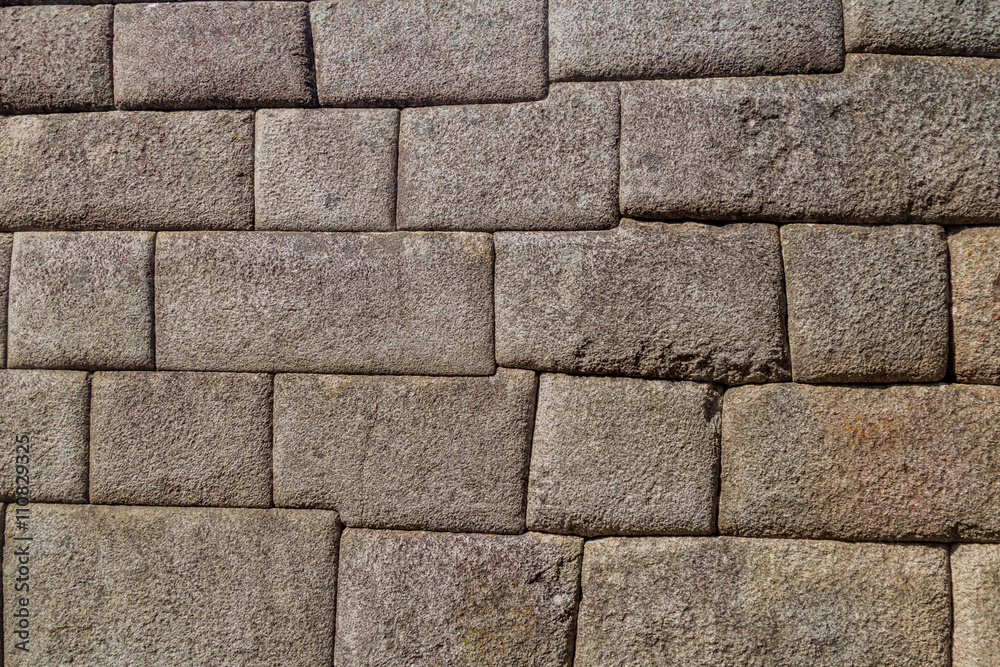 Fototapeta premium Detail of perfect Inca stonework of Temple of the Sun at Machu Picchu ruins, Peru