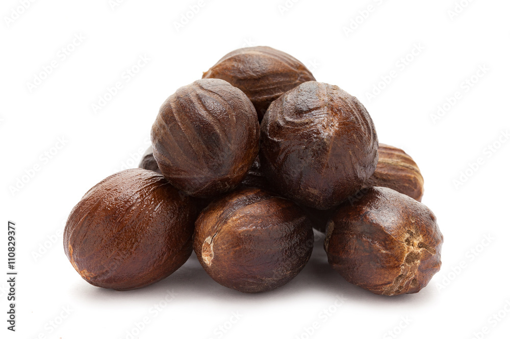 Mature Organic Nutmeg (Myristica fragrans) isolated on white background. Macro closeup Front view. Mature Organic Nutmeg (Myristica fragrans) isolated on white background. Macro closeup Front view.