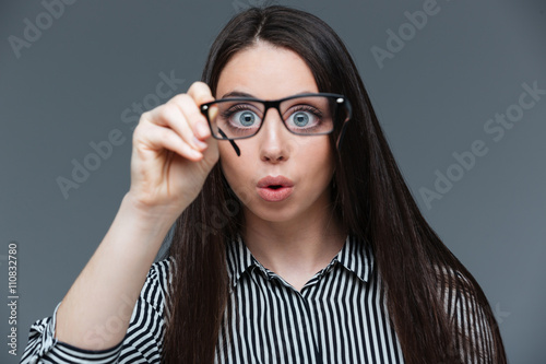 Funny woman holding glasses