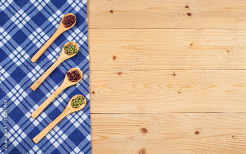 Tablecloth, wooden spoon, on wood textured background