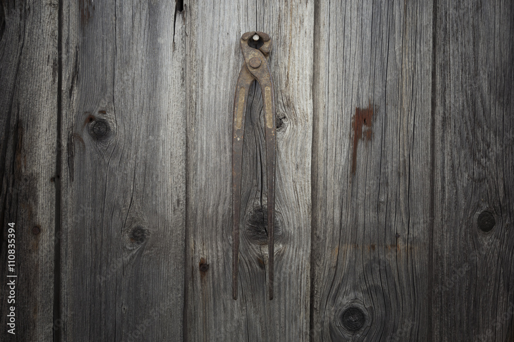 Rusty and grungy old tool on dark wood background Rusty and grungy old tool on dark wood background