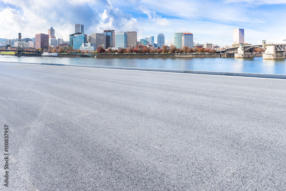 empty asphalt road with cityscape and skyline of portland empty asphalt road with cityscape and skyline of portland