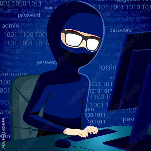 Hacker man typing on computer breaking system security code wearing balaclava and dark clothing to conceal his identity