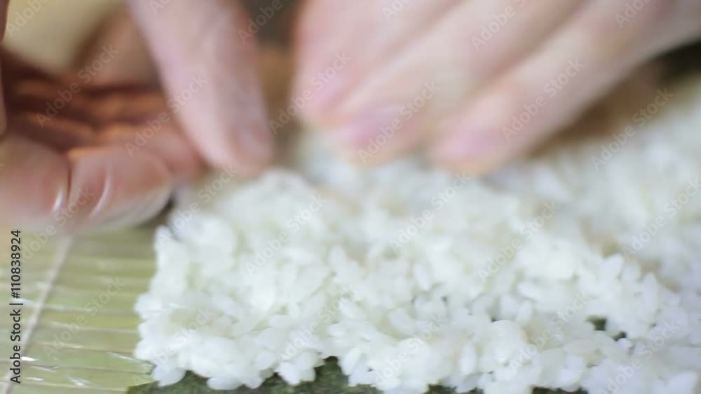 Sushi chef preparing rice for sushi roll in studio Sushi chef preparing rice for sushi roll in studio