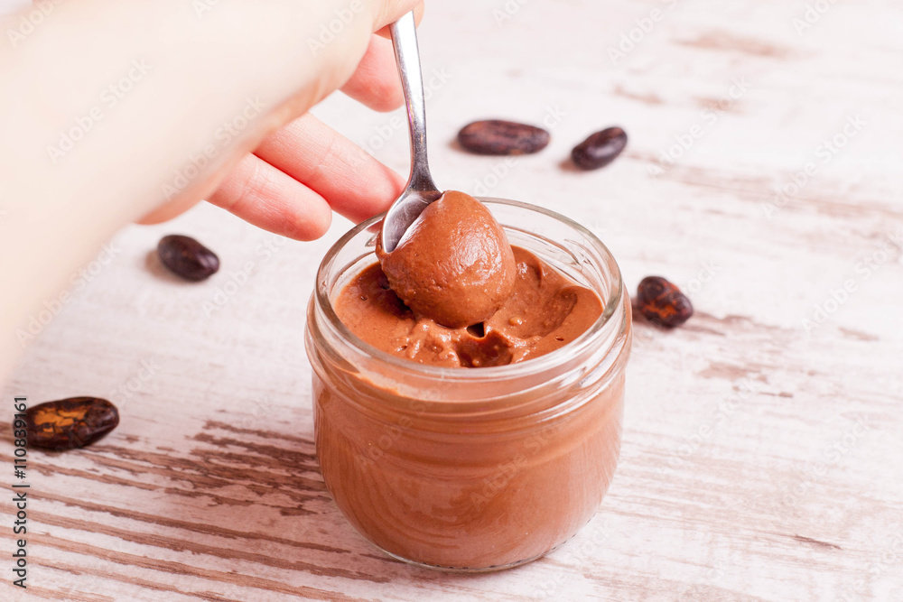 chocolate paste with nuts in a glass jar closeup chocolate paste with nuts in a glass jar closeup