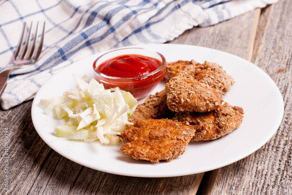 chicken nuggets with tomate sauce and vegetables on wooden board chicken nuggets with tomate sauce and vegetables on wooden board