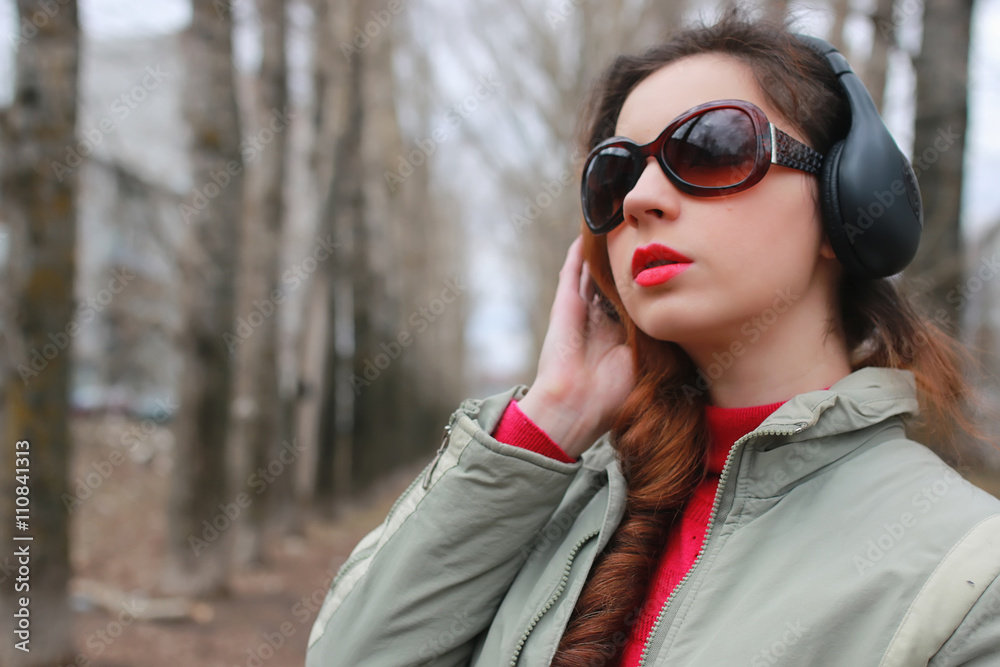 woman with headphones in park autumn woman with headphones in park autumn