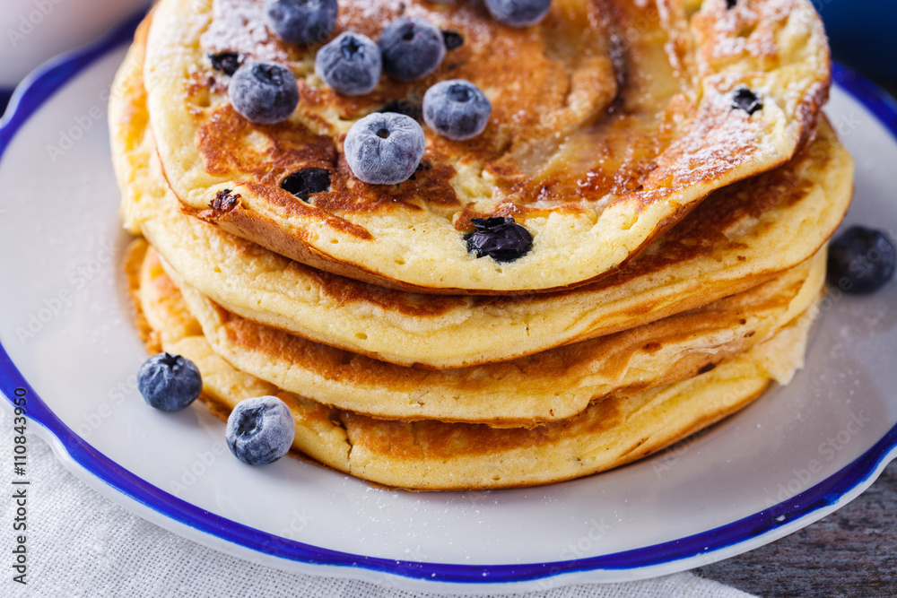 Pancake with banana , blueberries and honey.