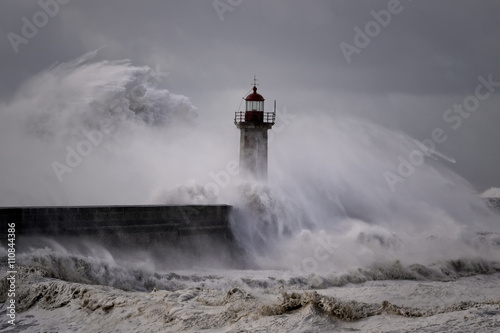 Stormy waves over old lighthouse