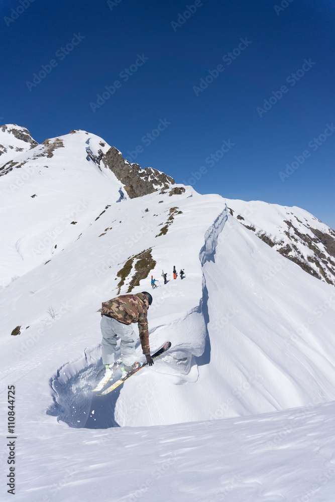 Ski rider jumping on mountains. Extreme ski freeride sport.