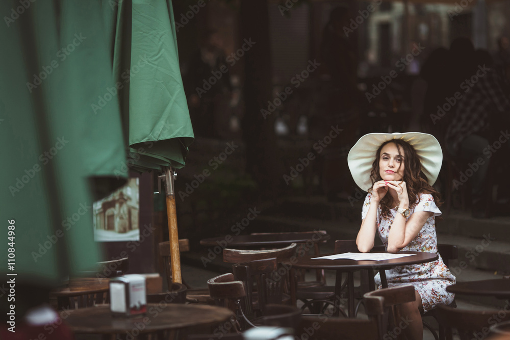 Young woman sitting thoughtful in the cafe