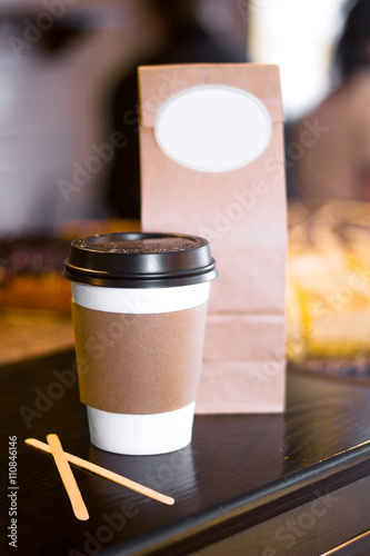 Disposable Paper Cup of Coffee or Tea, covered with black plasti photo