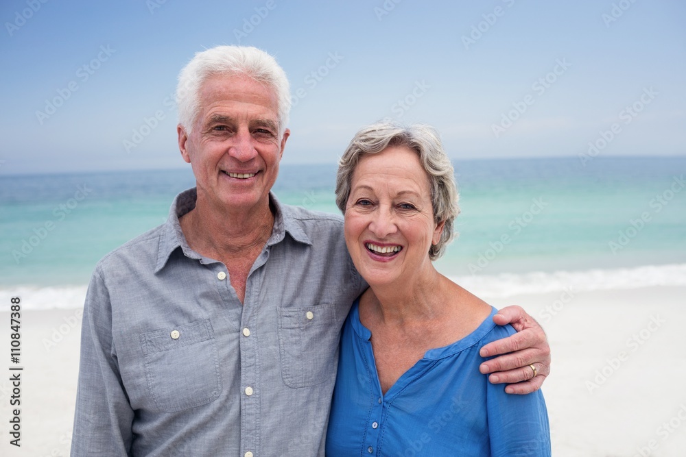 Happy senior couple embracing each other on the beach