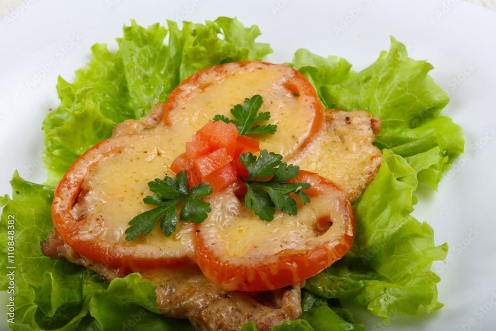 Pork baked with tomato and cheese