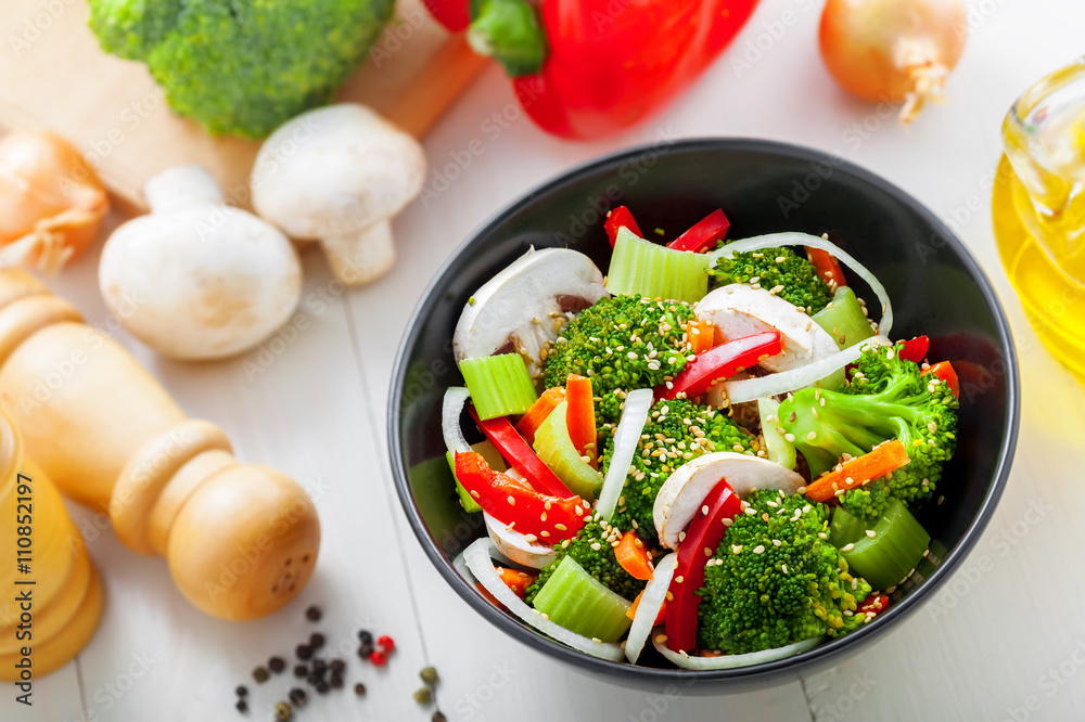 Bowl of delicious salad made of vegetables. Healthy vegetarian food. Top view. Bowl of delicious salad made of vegetables. Healthy vegetarian food. Top view.