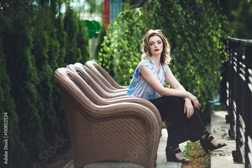 beautiful blonde sitting on big chair