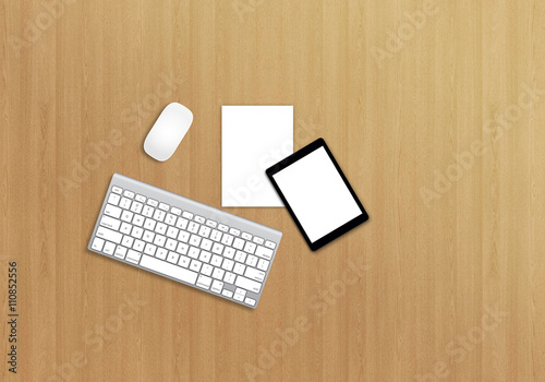 Office desk top view mock up image with keyboard, mouse, paper and tablet. Wooden background