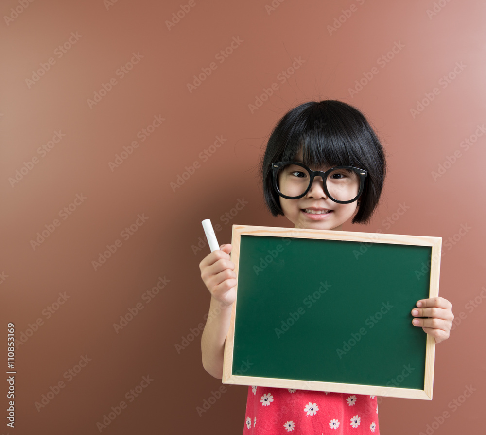 Asian school kid with chalk and chalkboard Asian school kid with chalk and chalkboard