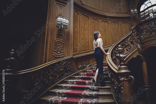 Charming  Lady climbs high up the ladder