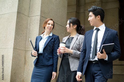 Group of business people walking out of office photo