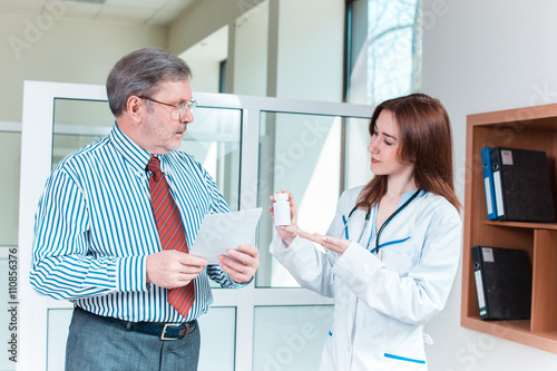 The patient and his doctor in medical office photo