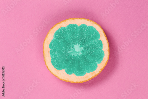 Top view popart grapefruit green color on a pink background. Grapefruit in the style of pop art in the center of the frame. Bright fruit grapefruit.