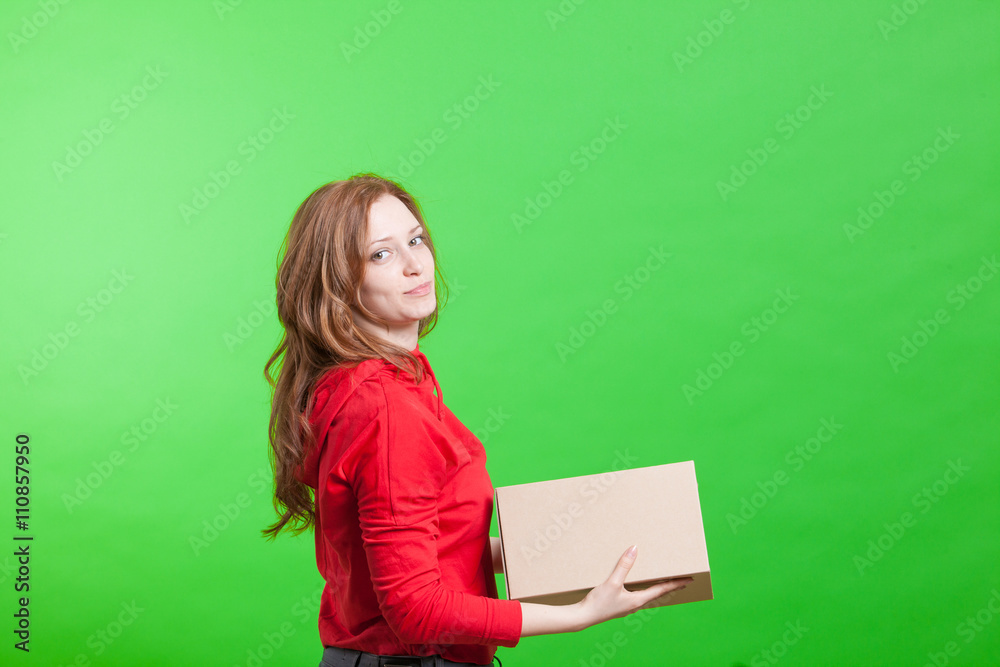 Woman holding cardboard box on green background Woman holding cardboard box on green background