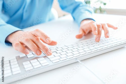 Men office worker typing on the keyboard