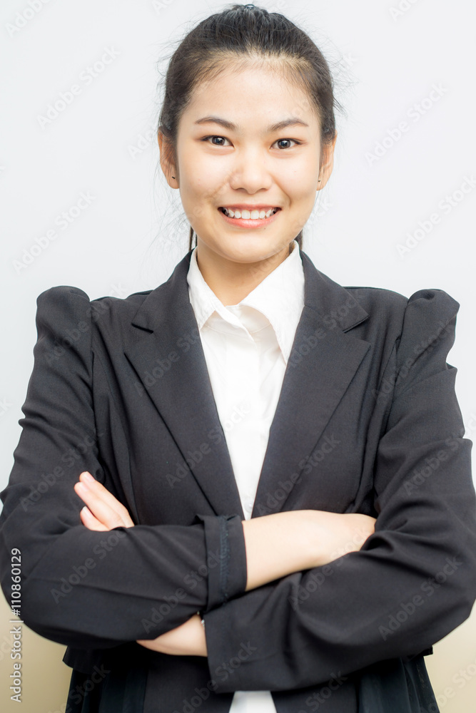 Happy young asian girl with folded arms in black suit Happy young asian girl with folded arms in black suit
