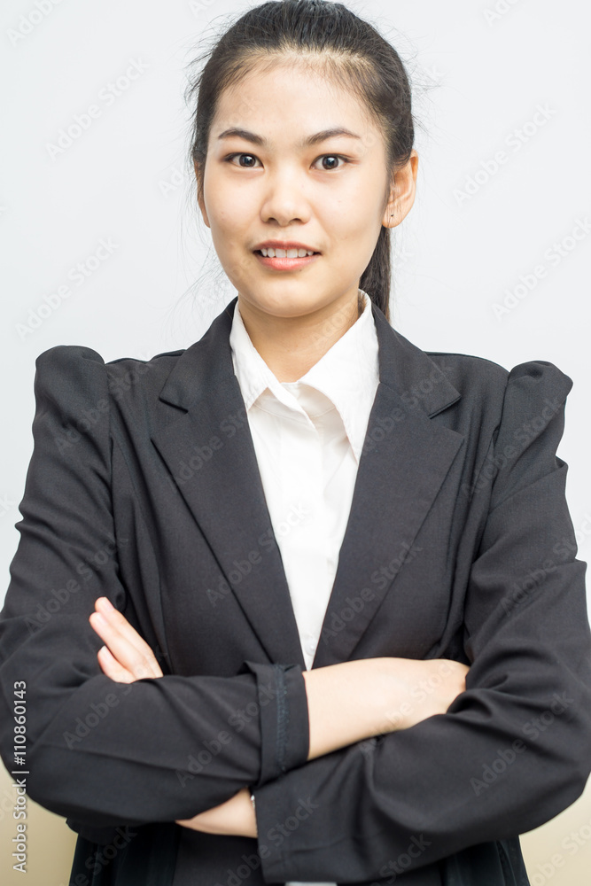 Happy young asian girl with folded arms in black suit Happy young asian girl with folded arms in black suit