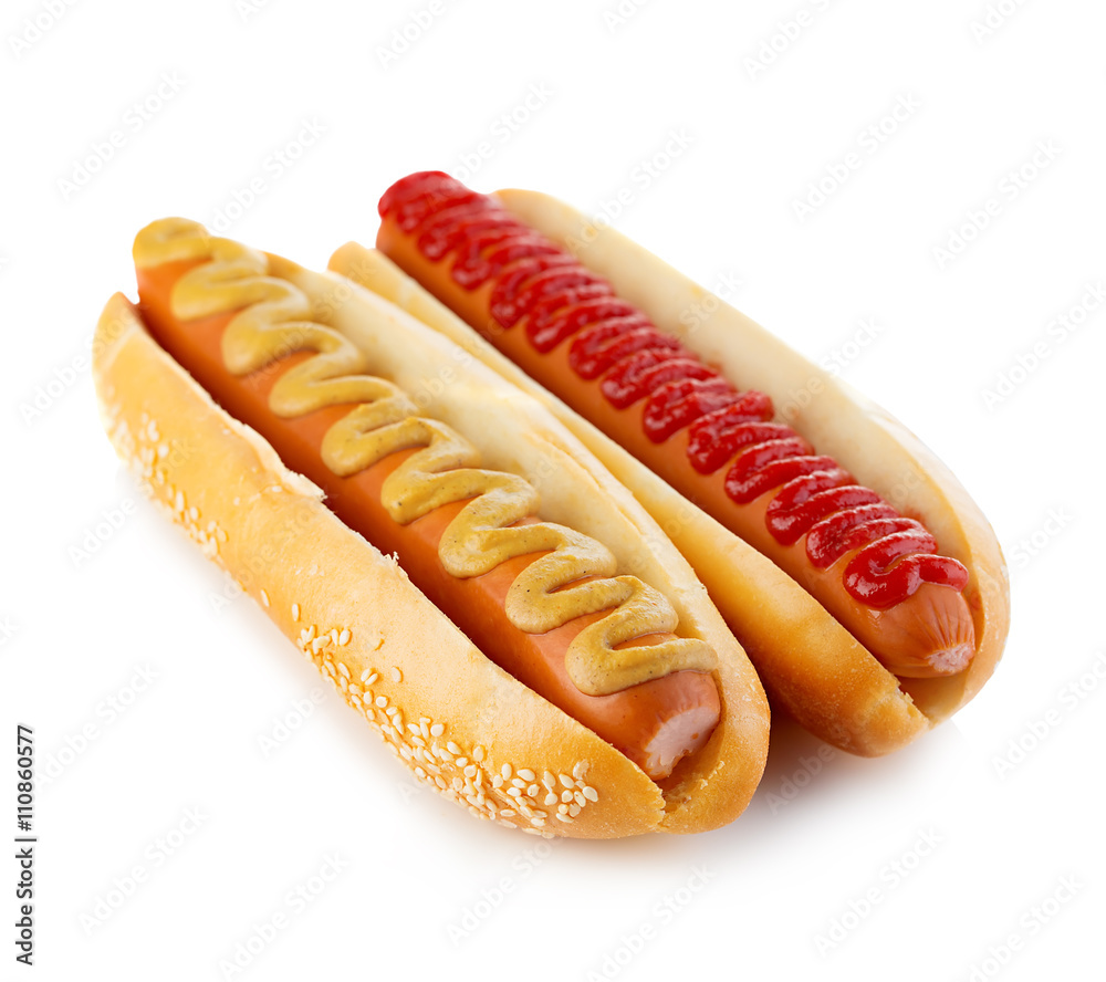 Classic hot dogs with mustard and ketchup close-up on a white background. Fast food. Classic hot dogs with mustard and ketchup close-up on a white background. Fast food.