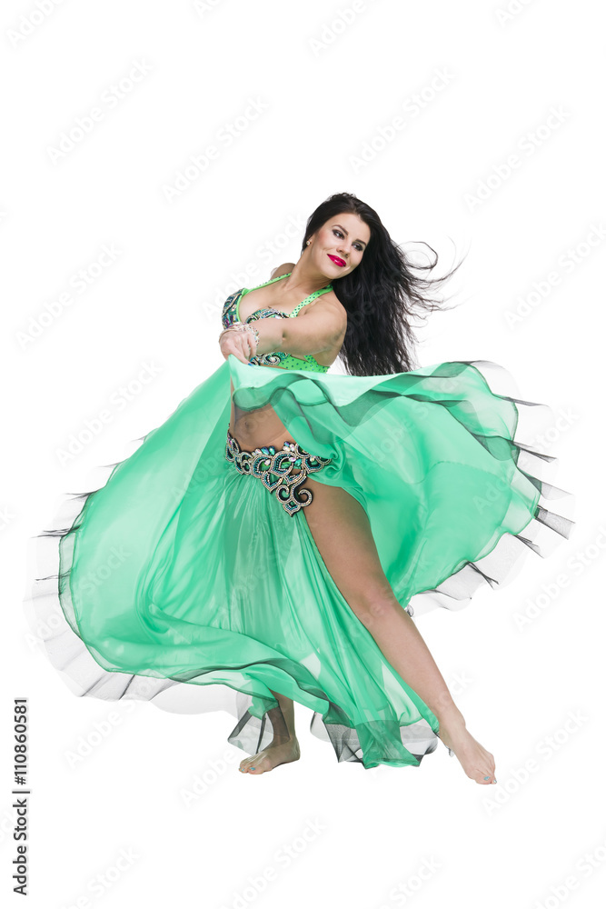 Young beautiful exotic eastern women performs belly dance in ethnic green dress. Isolated on white background Young beautiful exotic eastern women performs belly dance in ethnic green dress. Isolated on white background