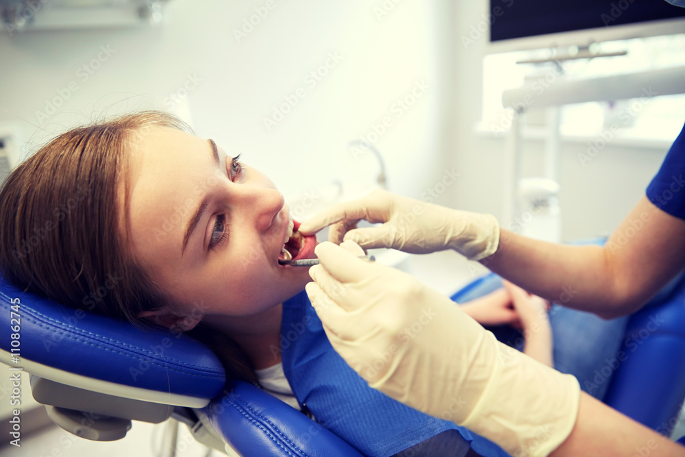 female dentist checking patient girl teeth female dentist checking patient girl teeth