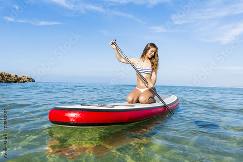 Woman practicing paddle © ikostudio