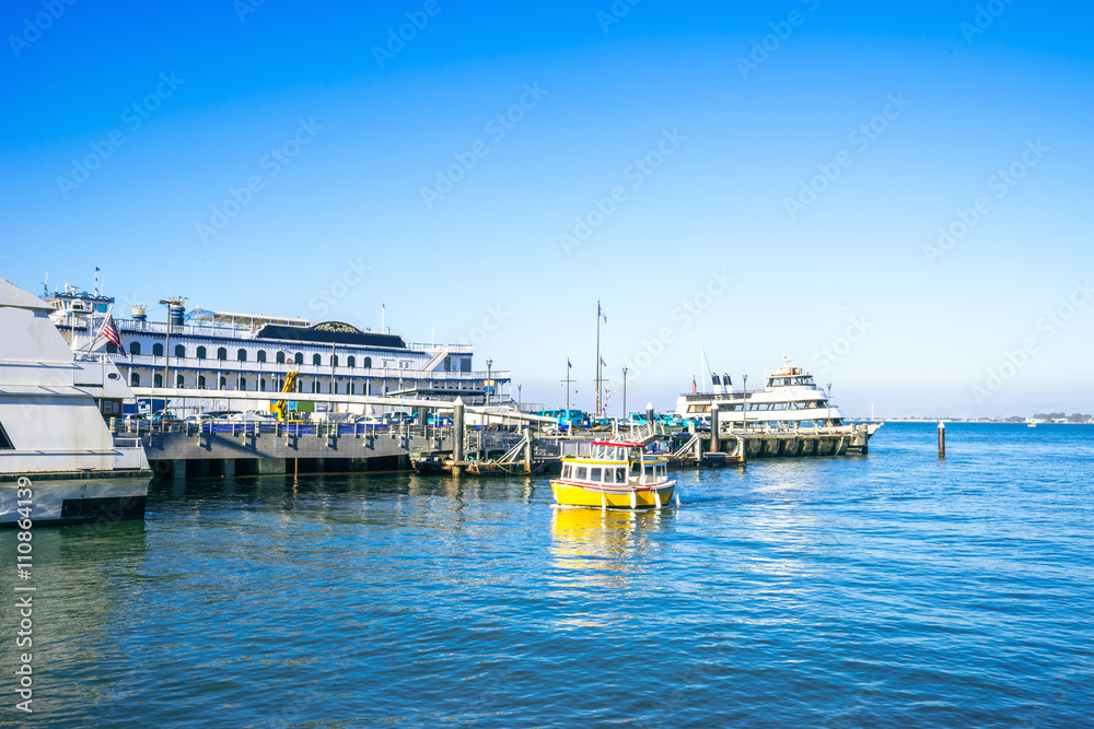 buildings on dock with yacht and sail boats on tranquil water