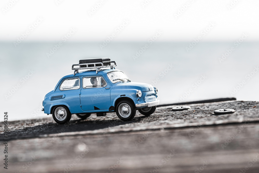 Cute blue retro travel car with luggage. Macro photo Cute blue retro travel car with luggage. Macro photo