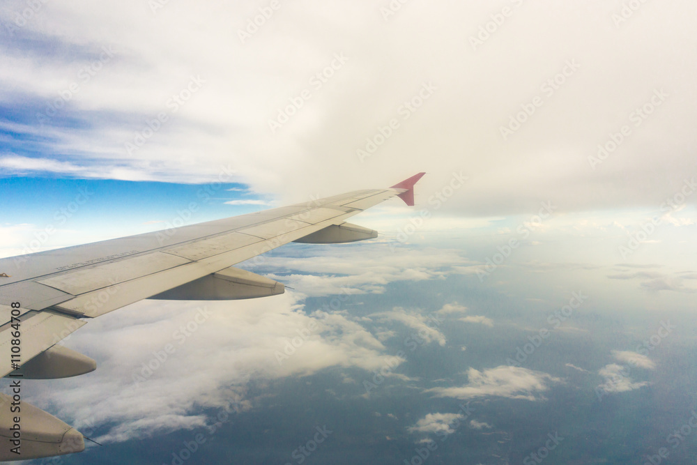 Wing of airplane over the clouds Wing of airplane over the clouds