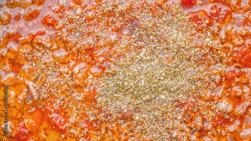 Stew meat with seasoning and tomatoes background close-up