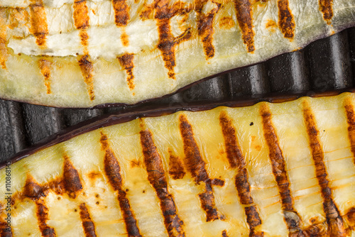 Grilled eggplant slices on the metal background top view