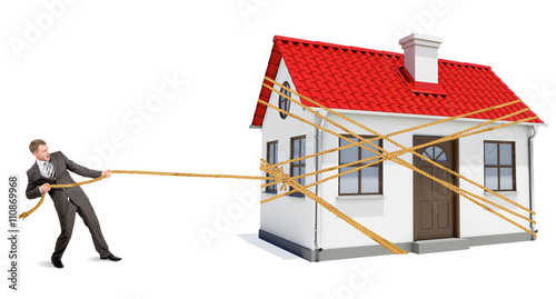 Man pulling rope to move wooden house 