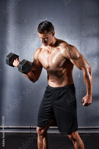 Man holding a dumbbell doing a fitness workout