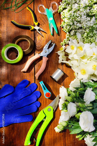 Garden tools, Tools for floristics and flowers on a wooden table. photo