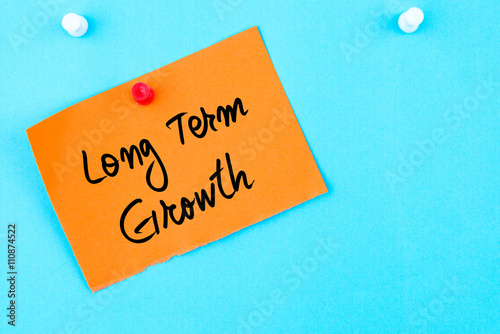 Long Term Growth written on orange paper note
