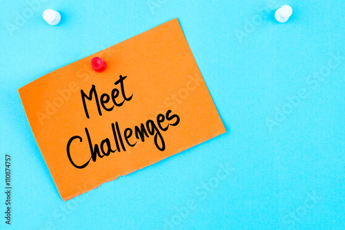 Meet Challenges written on orange paper note