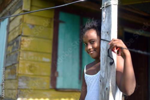 native Nicaraguan girl smiling  clapboard house Big Corn Island photo