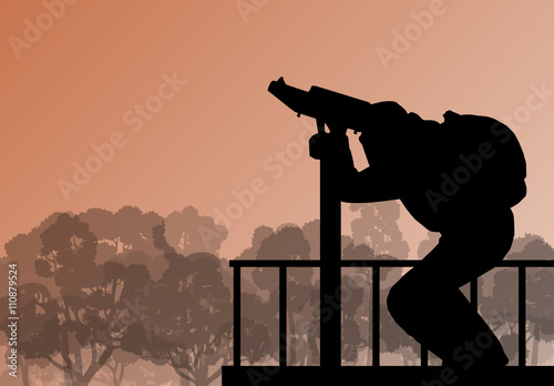 Tourist man looking through coin operated binoculars tower view